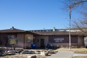 Visitor's Center of Shepherd of the Hills Trout Hatchery with Table Rock Dam in the background.