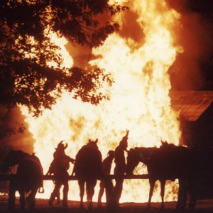 Scene from the "Shepherd of the Hills Outdoor Drama" with the  Bald Knobbers burning cabin. Notice the outline of their distinctive masks.